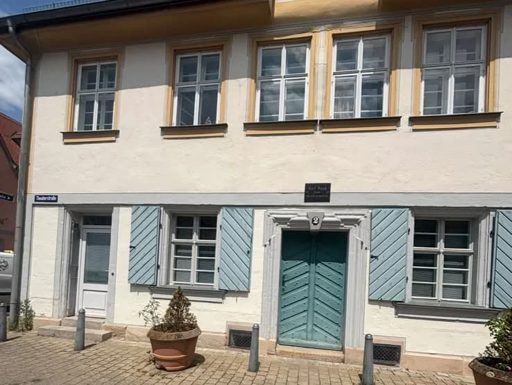Altbaufassade in Erlangen mit ausgewitterten Fensterläden vor der Aufbereitung